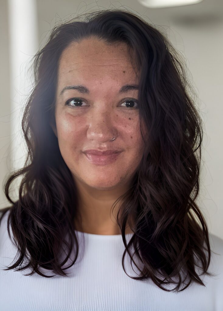 A woman with long hair and a smile.